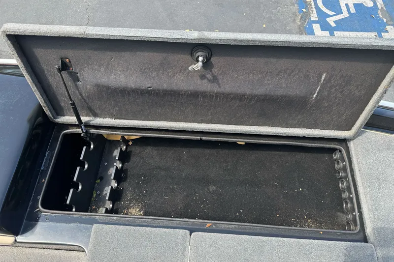 Slide: The Image of Open storage compartment in a 2003 Gambler 2100 boat, showing interior details. - 16