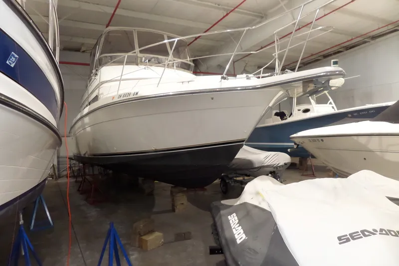 The Image of 1995 Carver 380 Santego yacht stored indoors alongside other boats. - 1