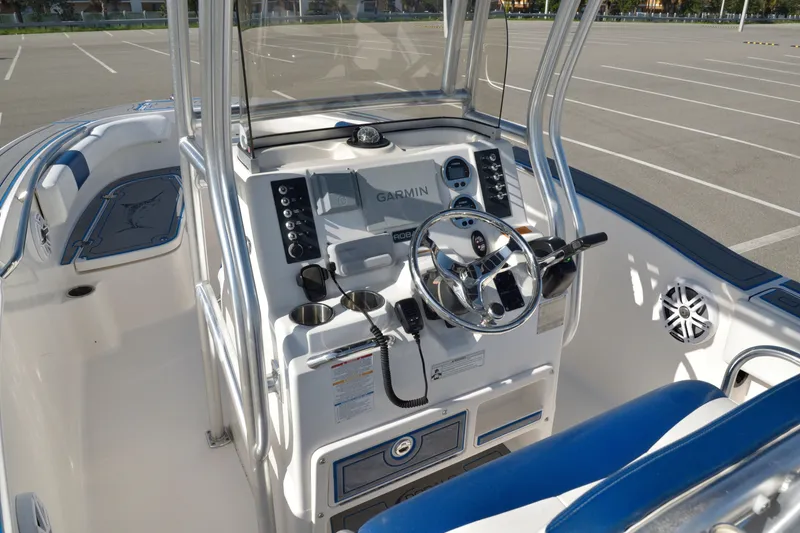 Slide: The Image of 2016 Robalo R200 Center Console boat interior with Garmin navigation system and steering wheel. - 14