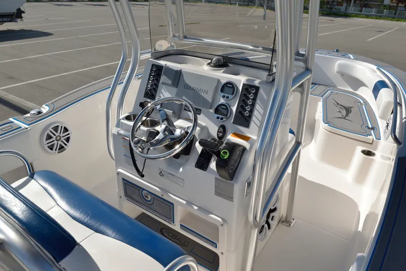 Slide: The Image of 2016 Robalo R200 Center Console boat interior with steering wheel and control panel. - 16