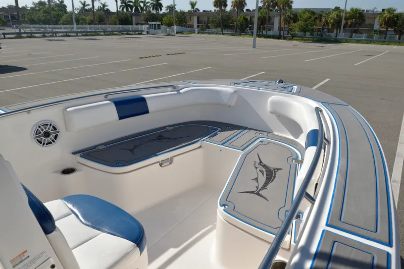 Slide: The Image of 2016 Robalo R200 Center Console boat interior with blue accents in a parking lot. - 23