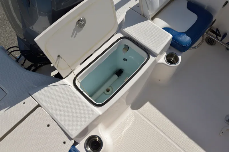 Slide: The Image of 2016 Robalo R200 Center Console boat with open storage compartment and seating. - 11