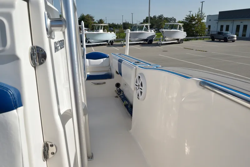 Slide: The Image of 2016 Robalo R200 Center Console boat interior with blue seating in a parking lot. - 19