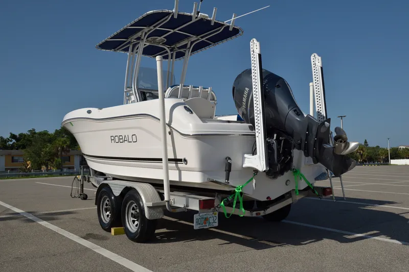 Slide: The Image of 2016 Robalo R200 Center Console boat on trailer in parking lot. - 1