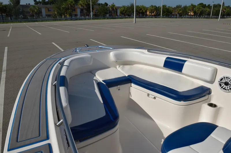 Slide: The Image of 2016 Robalo R200 Center Console boat interior with blue and white seating in a parking lot. - 27