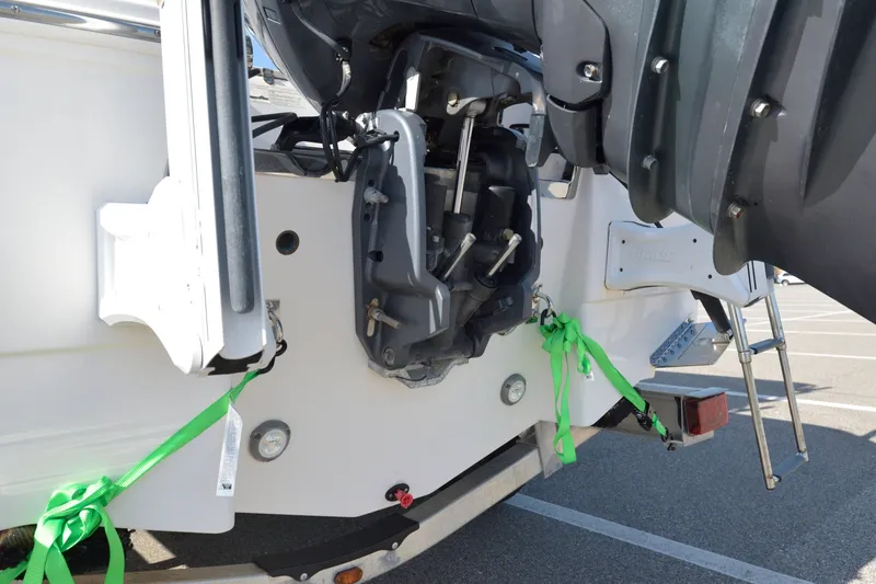 Slide: The Image of 2016 Robalo R200 Center Console boat engine with green tie-down straps. - 7