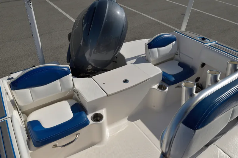 Slide: The Image of 2016 Robalo R200 Center Console boat interior with blue and white seating and engine. - 10