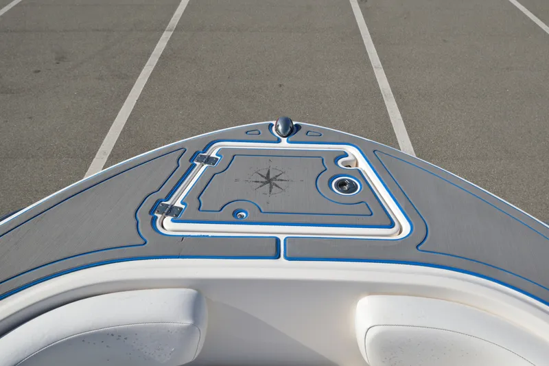 Slide: The Image of 2016 Robalo R200 Center Console boat deck with compass design, parked on asphalt. - 25