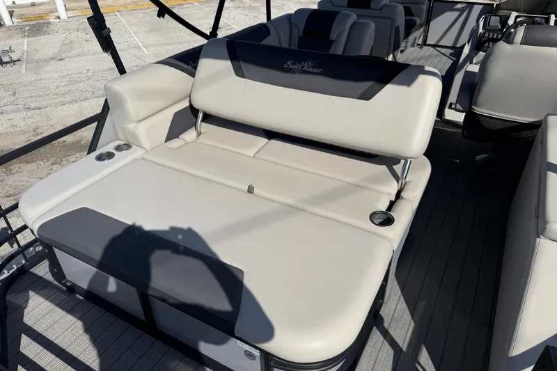 Slide: The Image of 2023 SunChaser Geneva Sport 23 SB boat interior with comfortable seating and cup holders. - 13
