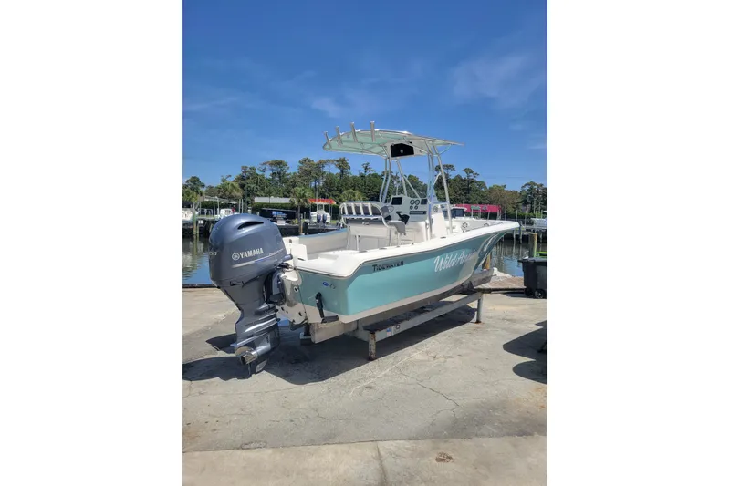 Slide: The Image of 2020 Tidewater 198 CC Adventure boat with Yamaha engine, docked under clear blue sky. - 1
