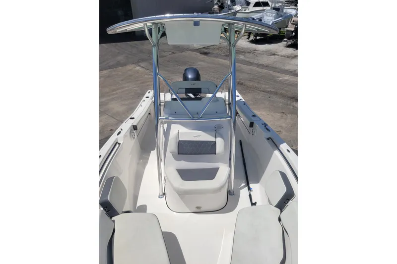 Slide: The Image of 2020 Tidewater 198 CC Adventure boat with T-top and seating, docked at marina. - 4