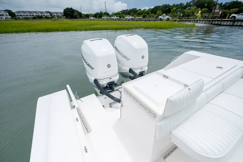 Slide: The Image of 2008 Regulator 29 Forward Seating boat with twin Mercury outboard engines on calm water. - 16