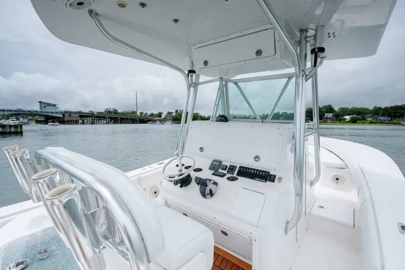 Slide: The Image of 2008 Regulator 29 Forward Seating boat interior with helm, steering wheel, and rod holders. - 21