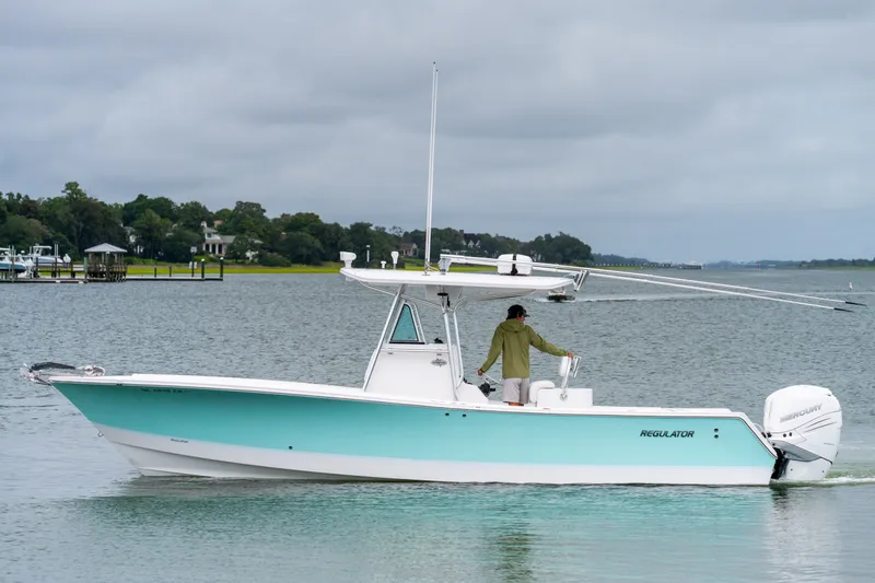 Slide: The Image of 2008 Regulator 29 Forward Seating boat on calm water, overcast sky. - 9