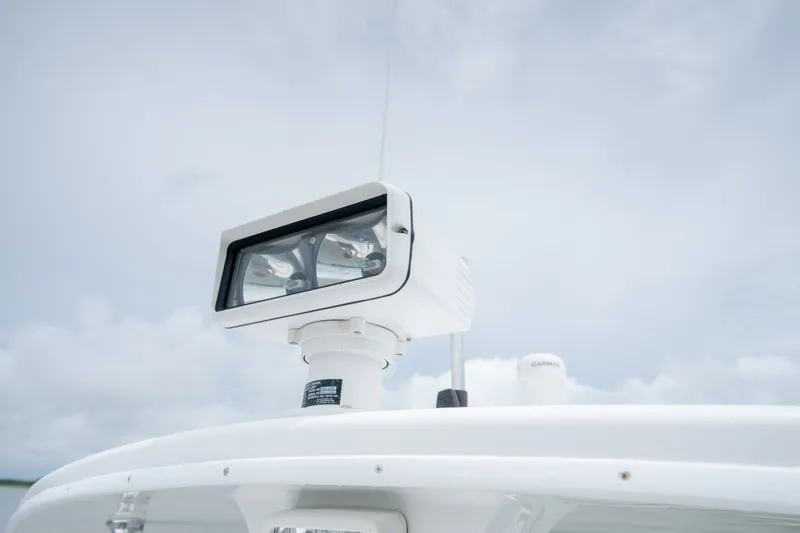 Slide: The Image of Spotlight on 2008 Regulator 29 Forward Seating boat against cloudy sky. - 39