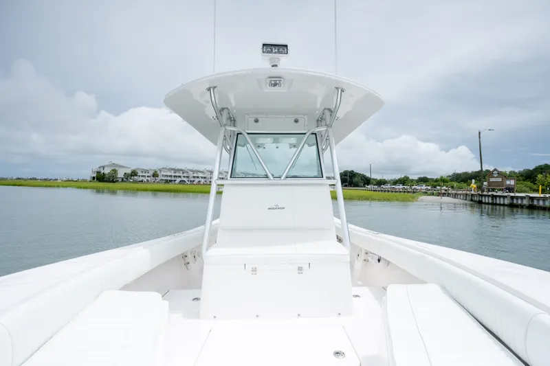 Slide: The Image of 2008 Regulator 29 Forward Seating boat on calm water, showcasing sleek design and spacious seating. - 29