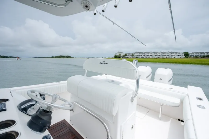 Slide: The Image of 2008 Regulator 29 Forward Seating boat on calm water, overcast sky. - 26