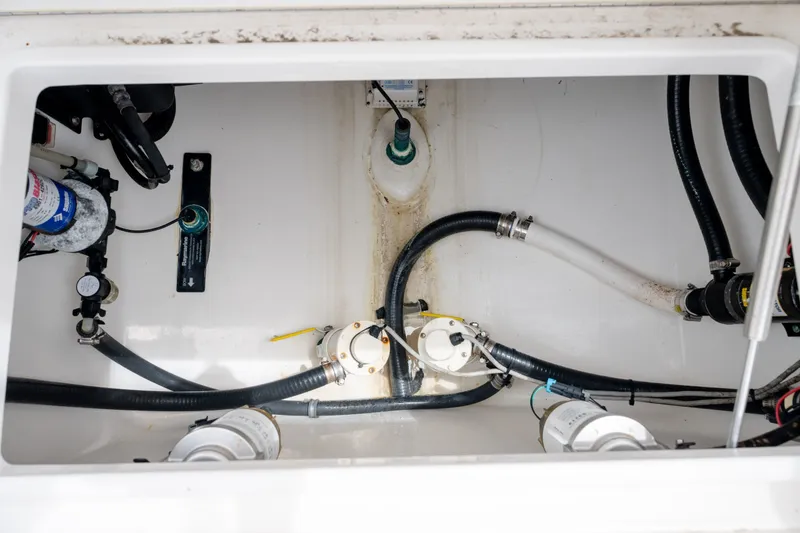Slide: The Image of 2008 Regulator 29 Forward Seating boat interior with visible plumbing and wiring components. - 40