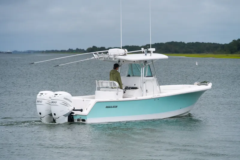Slide: The Image of 2008 Regulator 29 Forward Seating boat with twin engines on a calm waterway. - 5