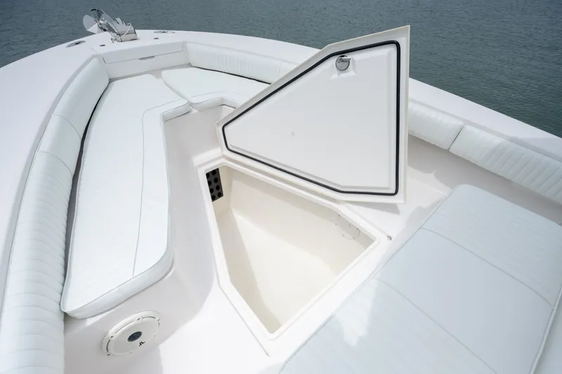Slide: The Image of 2008 Regulator 29 Forward Seating boat with open storage compartment and cushioned seating. - 36