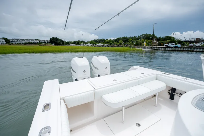 Slide: The Image of 2008 Regulator 29 Forward Seating boat with twin Mercury engines on a calm waterway. - 13