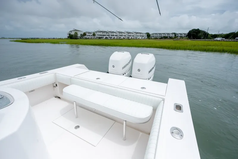Slide: The Image of 2008 Regulator 29 Forward Seating boat with twin Mercury engines on a calm waterway. - 15