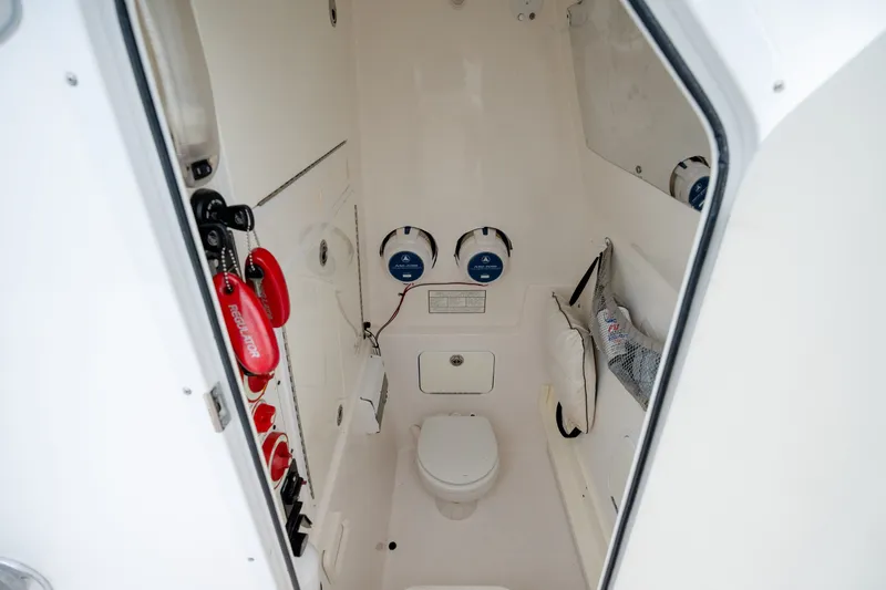 Slide: The Image of 2008 Regulator 29 Forward Seating boat interior with toilet and safety equipment. - 33