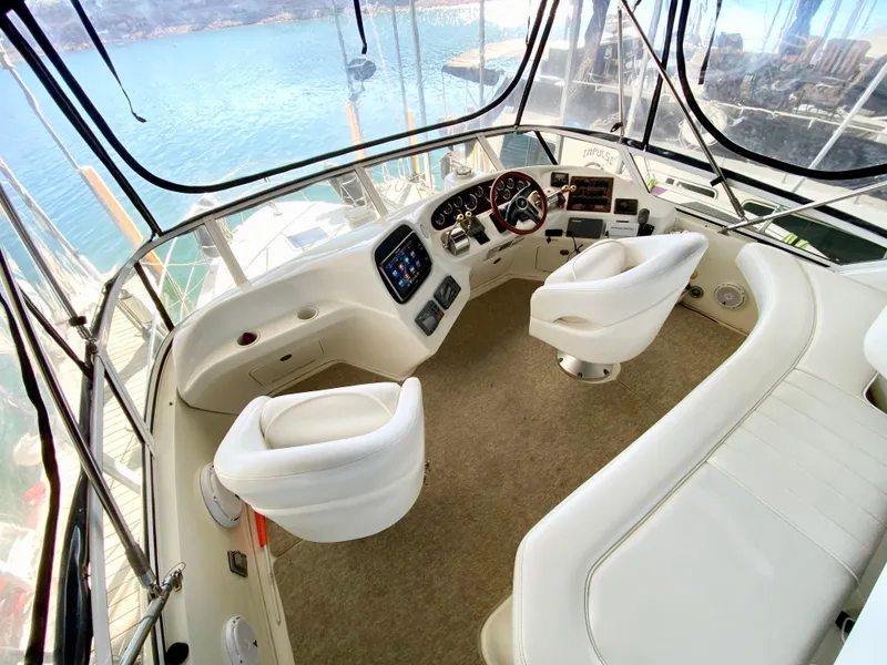 Slide: The Image of 2001 Sea Ray 380 Aft Cabin helm with white seating and panoramic view. - 8