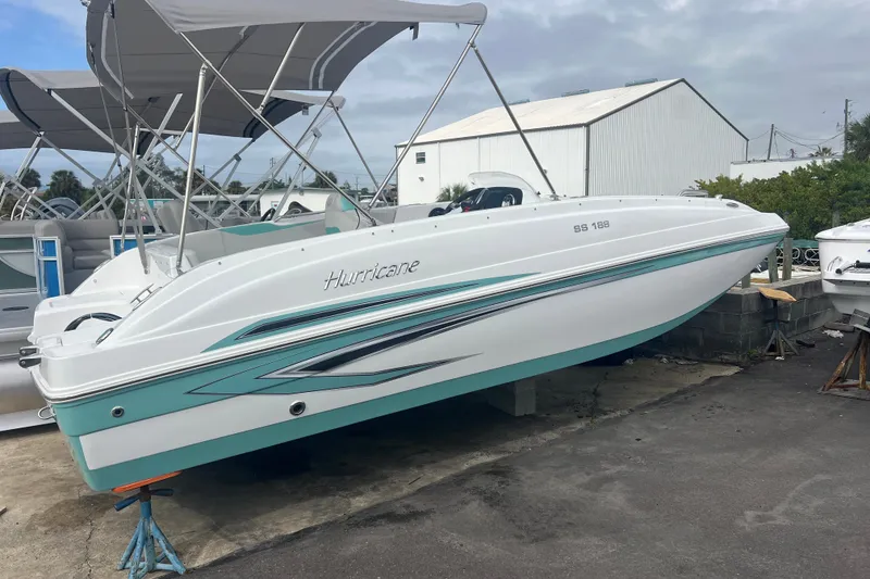 The Image of 2026 Hurricane SunDeck Sport 188 OB boat on display, featuring sleek design and canopy. - 0