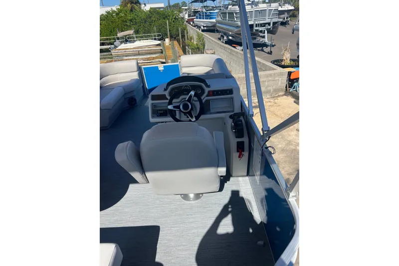 Slide: The Image of Interior of 2026 Godfrey EX 1886 CX boat with steering wheel and seating. - 13