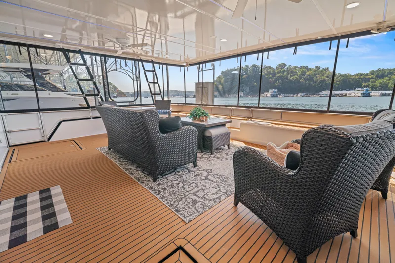 Slide: The Image of Luxurious 1999 Stardust Cruisers houseboat interior with wicker furniture and scenic water views. - 40