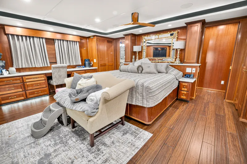 Slide: The Image of Luxurious bedroom interior on 1999 Stardust Cruisers houseboat, featuring elegant wood finishes and modern decor. - 26