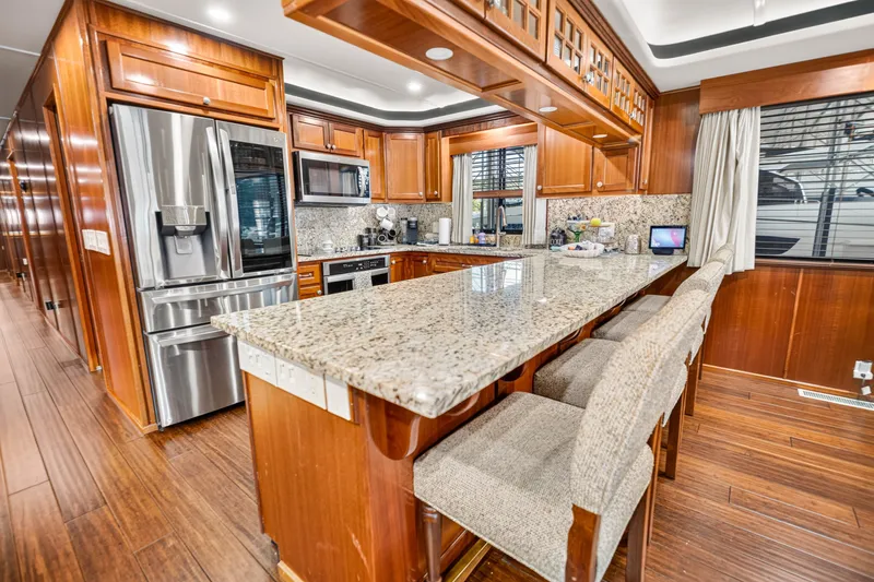 Slide: The Image of Luxurious kitchen interior of 1999 Stardust Cruisers houseboat with granite countertops and modern appliances. - 13