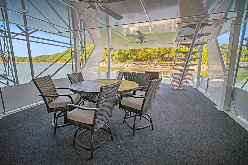 Slide: The Image of Spacious deck on 1999 Stardust Cruisers houseboat with outdoor seating and scenic lake view. - 29