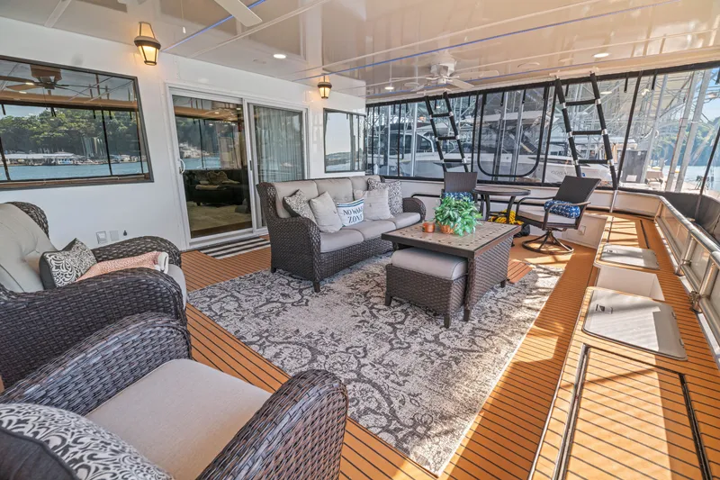 Slide: The Image of Luxurious 1999 Stardust Cruisers houseboat interior with elegant seating and scenic views. - 39