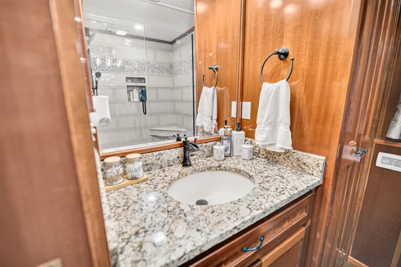 Slide: The Image of Luxurious bathroom in 1999 Stardust Cruisers houseboat with granite countertop and elegant fixtures. - 22