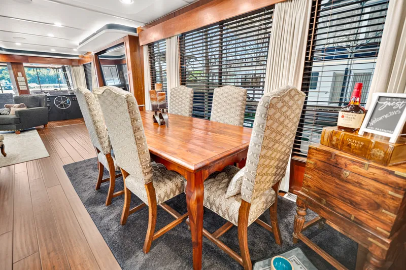 Slide: The Image of Luxurious dining area inside a 1999 Stardust Cruisers 20 x 123 houseboat, featuring elegant decor. - 14