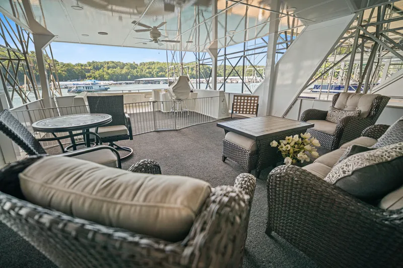 Slide: The Image of Luxurious 1999 Stardust Cruisers houseboat deck with wicker furniture and scenic lake view. - 35
