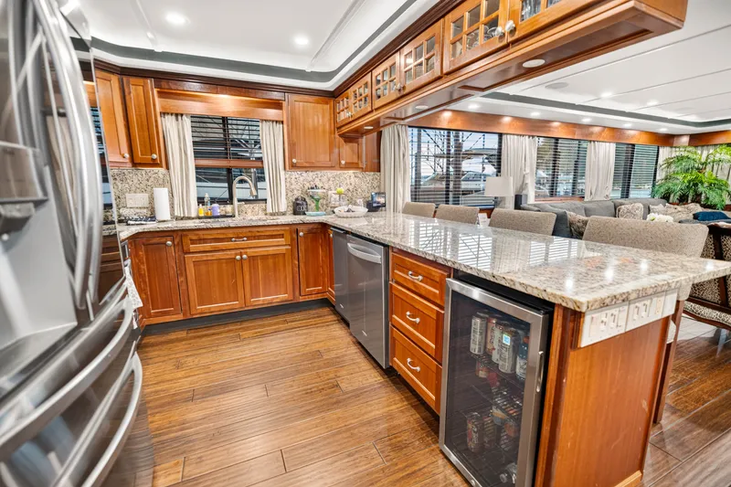 Slide: The Image of Luxurious kitchen interior of 1999 Stardust Cruisers houseboat with granite countertops and wooden cabinetry. - 16