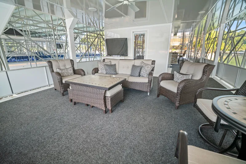 Slide: The Image of Luxurious 1999 Stardust Cruisers houseboat interior with wicker furniture and modern decor. - 34