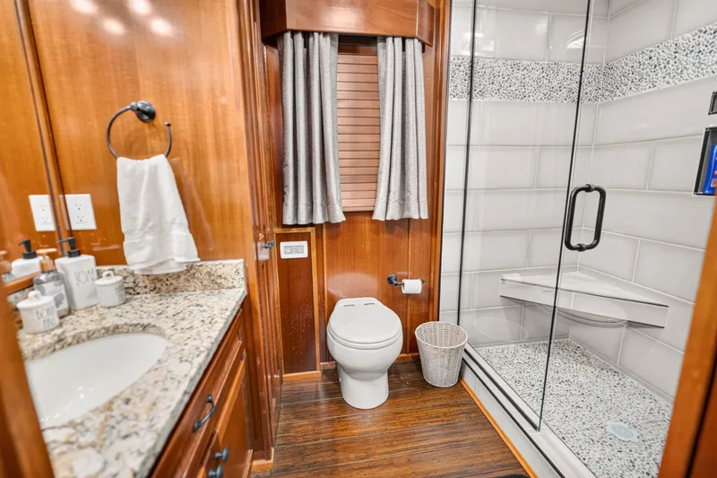 Slide: The Image of Luxurious bathroom in 1999 Stardust Cruisers houseboat with granite countertop and glass shower. - 20