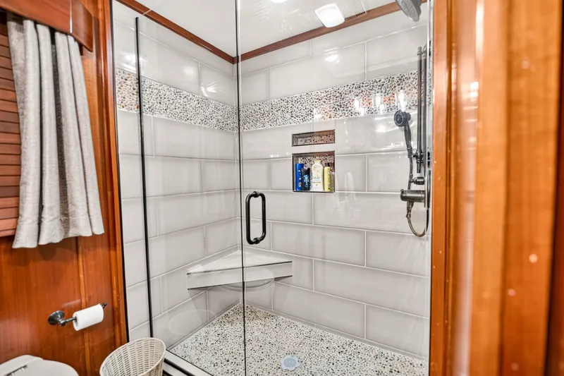 Slide: The Image of Luxurious shower in 1999 Stardust Cruisers houseboat, featuring glass doors and elegant tile design. - 19