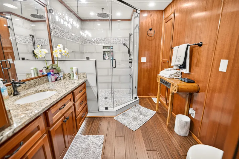 Slide: The Image of Luxurious bathroom in 1999 Stardust Cruisers houseboat with granite countertop and glass shower. - 28