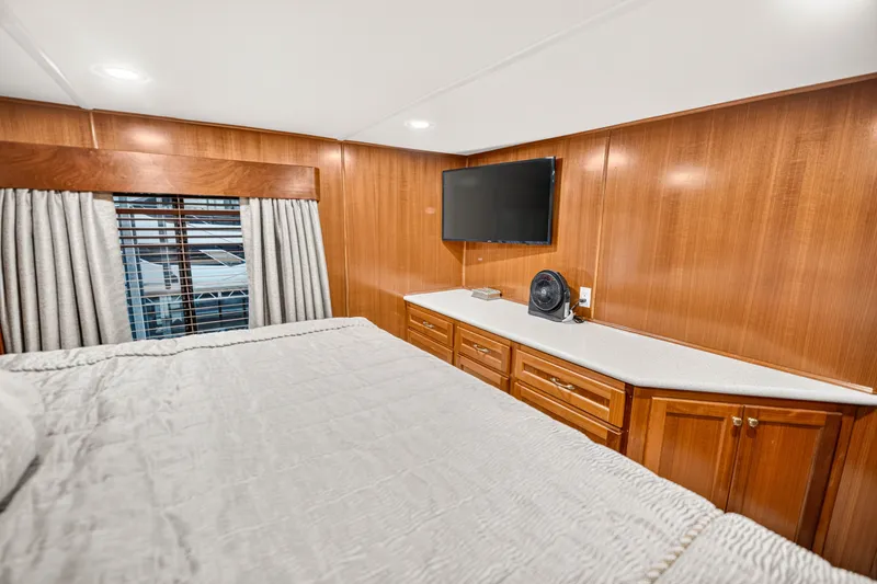 Slide: The Image of Luxurious bedroom interior of 1999 Stardust Cruisers houseboat with wood paneling and modern amenities. - 18