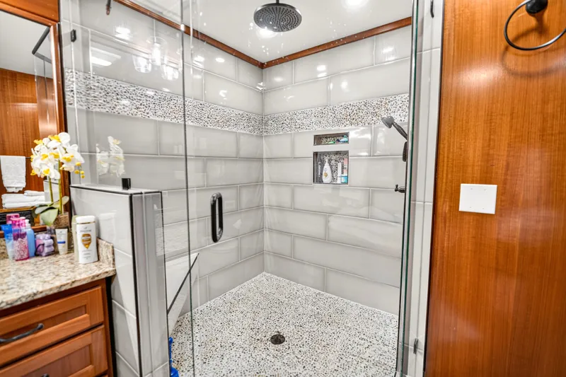 Slide: The Image of Luxurious shower in 1999 Stardust Cruisers houseboat, featuring elegant tile and glass enclosure. - 27