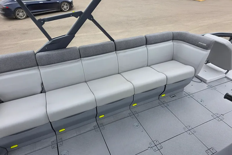 Slide: The Image of 2023 Sea-Doo Switch Sport 21 interior seating, featuring gray cushioned seats and modular flooring. - 10