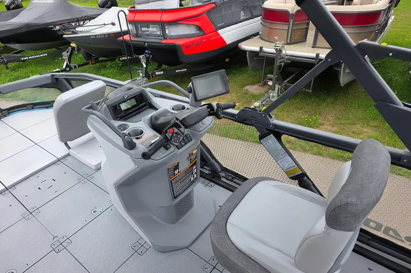 Slide: The Image of 2023 Sea-Doo Switch Sport 21 dashboard and seating area, featuring modern controls and navigation system. - 11