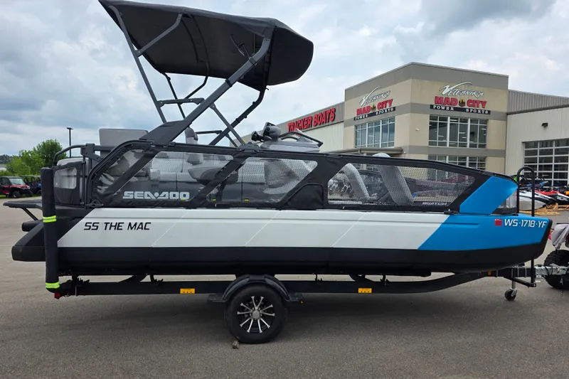 Slide: The Image of 2023 Sea-Doo Switch Sport 21 boat on trailer, parked outside dealership. - 4