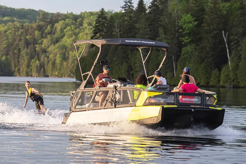 Slide: The Image of Manufacturer Provided Image: 2023 Sea-Doo Switch Sport 21 towing a wakeboarder on a scenic lake. - 19
