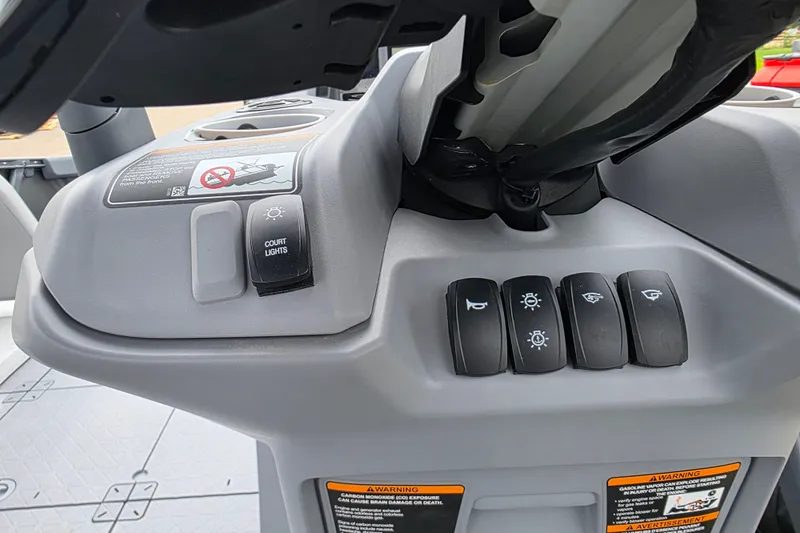 Slide: The Image of Control panel of 2023 Sea-Doo Switch Sport 21 with various switches and warning labels. - 15